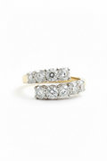18ct diamond ring on a white background, one with a yellow gold band featuring a wrap of round-cut diamonds.