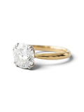A classic solitaire engagement ring featuring a round brilliant-cut diamond set in a polished yellow gold band, photographed on a clean white background with a soft shadow.