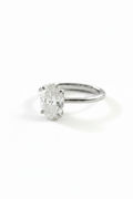 An oval-cut diamond engagement ring in a silver-toned four-prong setting on a plain white background.
