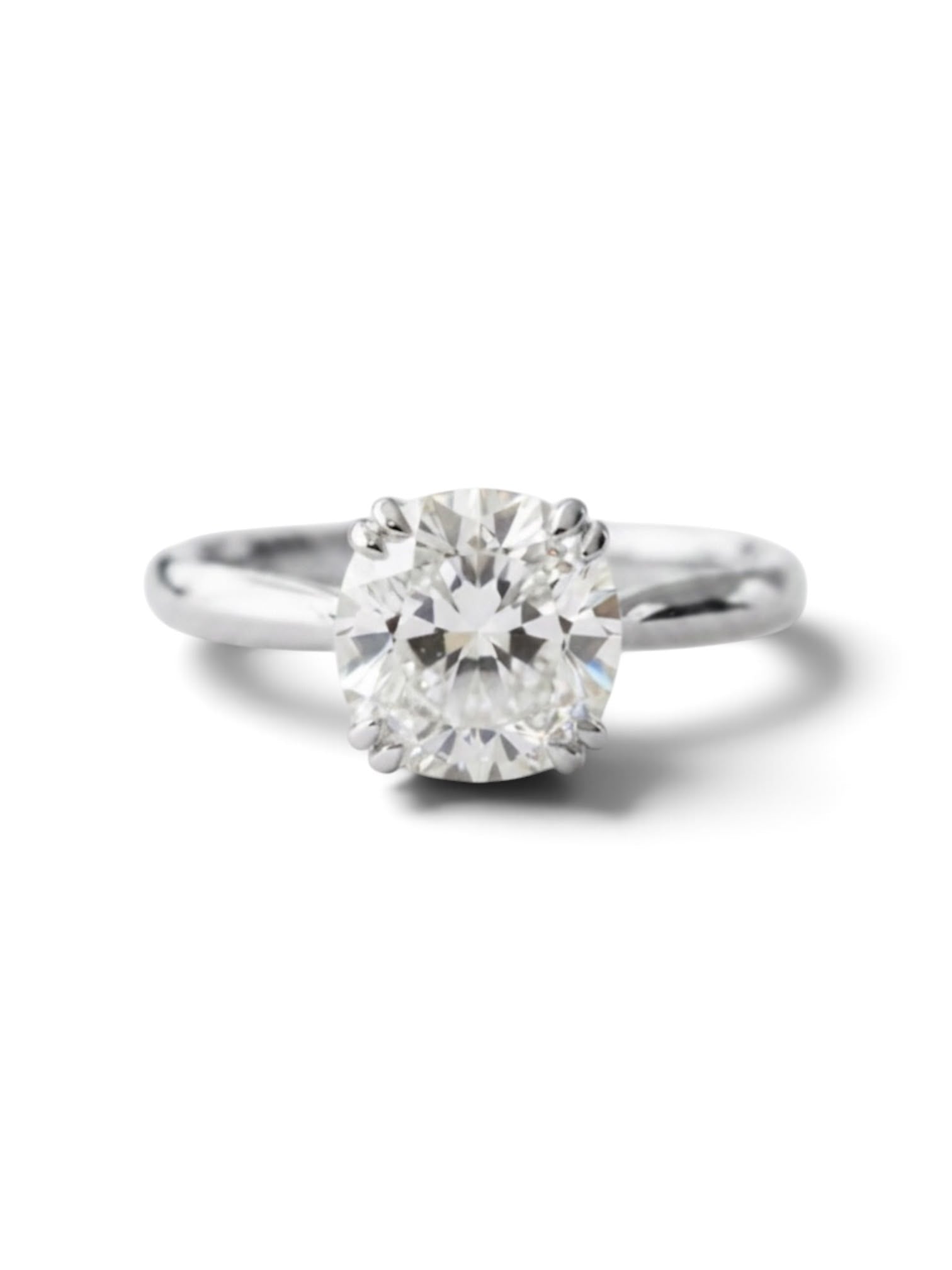 A classic solitaire engagement ring featuring a round brilliant-cut diamond set in a polished silver-colored metal band, shown against a clean white background with a soft shadow.